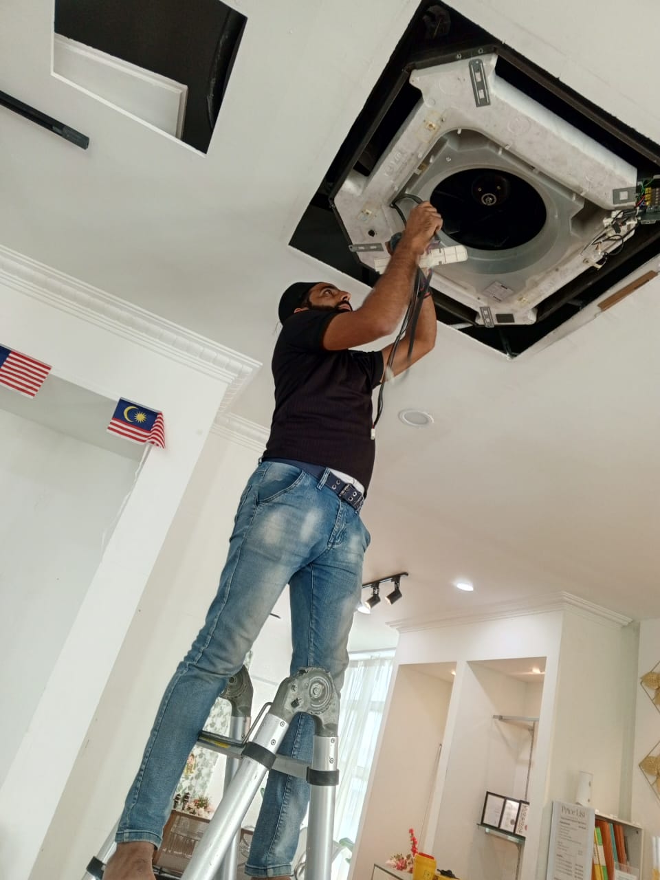 Aircon technician servicing outdoor unit